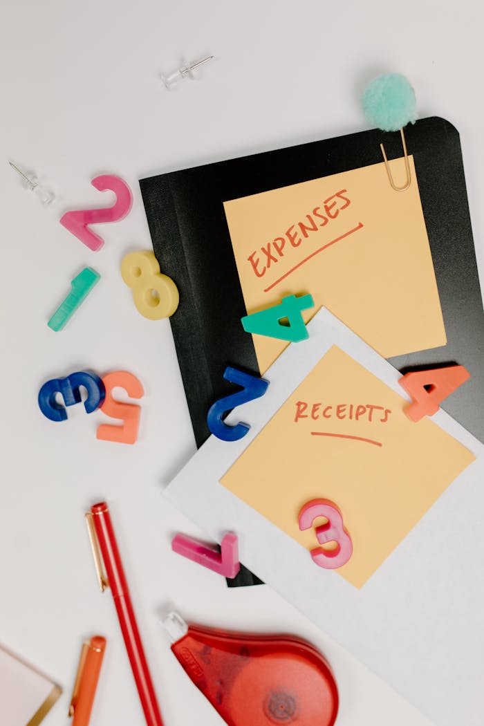 who-we-are-img Flat lay of colorful office supplies and sticky notes labeled 'Expenses' and 'Receipts'.